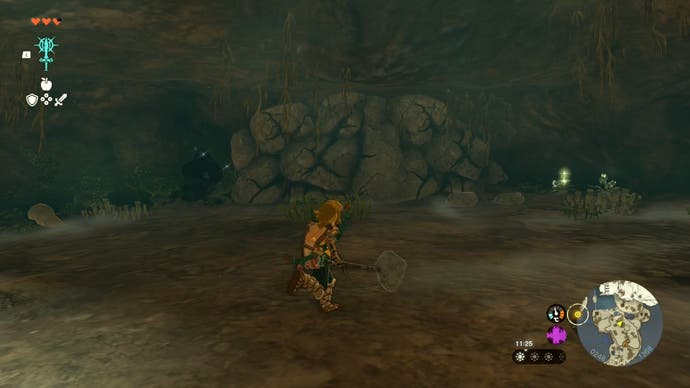 Image taken from The Legend of Zelda: Tears of the Kingdom showing Link exploring the Pondside Cave with a weapon in hand.