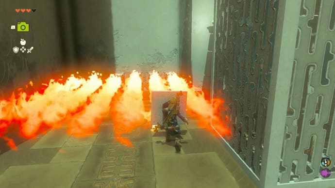 Zelda Tears of the Kingdom, Link is holding up a Stone shield to block fire as he walks into it in the Ijo-o Shrine.