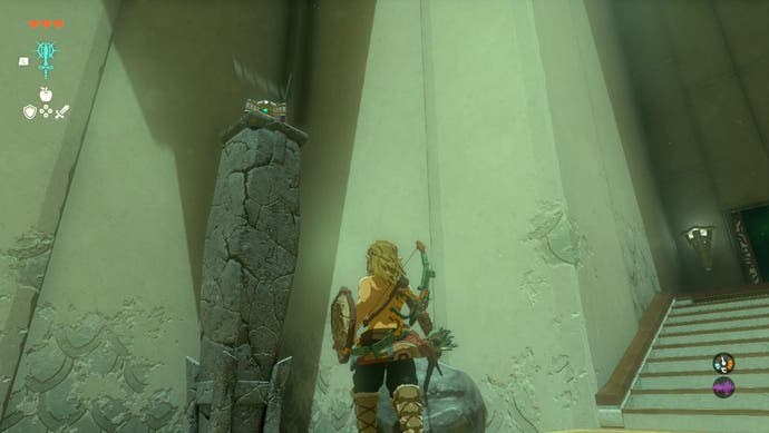 Link standing near a chest atop a pillar in the In-Isa Shrine in The Legend of Zelda: Tears of the Kingdom.