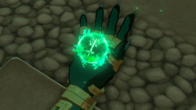 A close-up of Link's hand showing a green, glowing orb floating in his palm in The Legend of Zelda: Tears of the Kingdom.